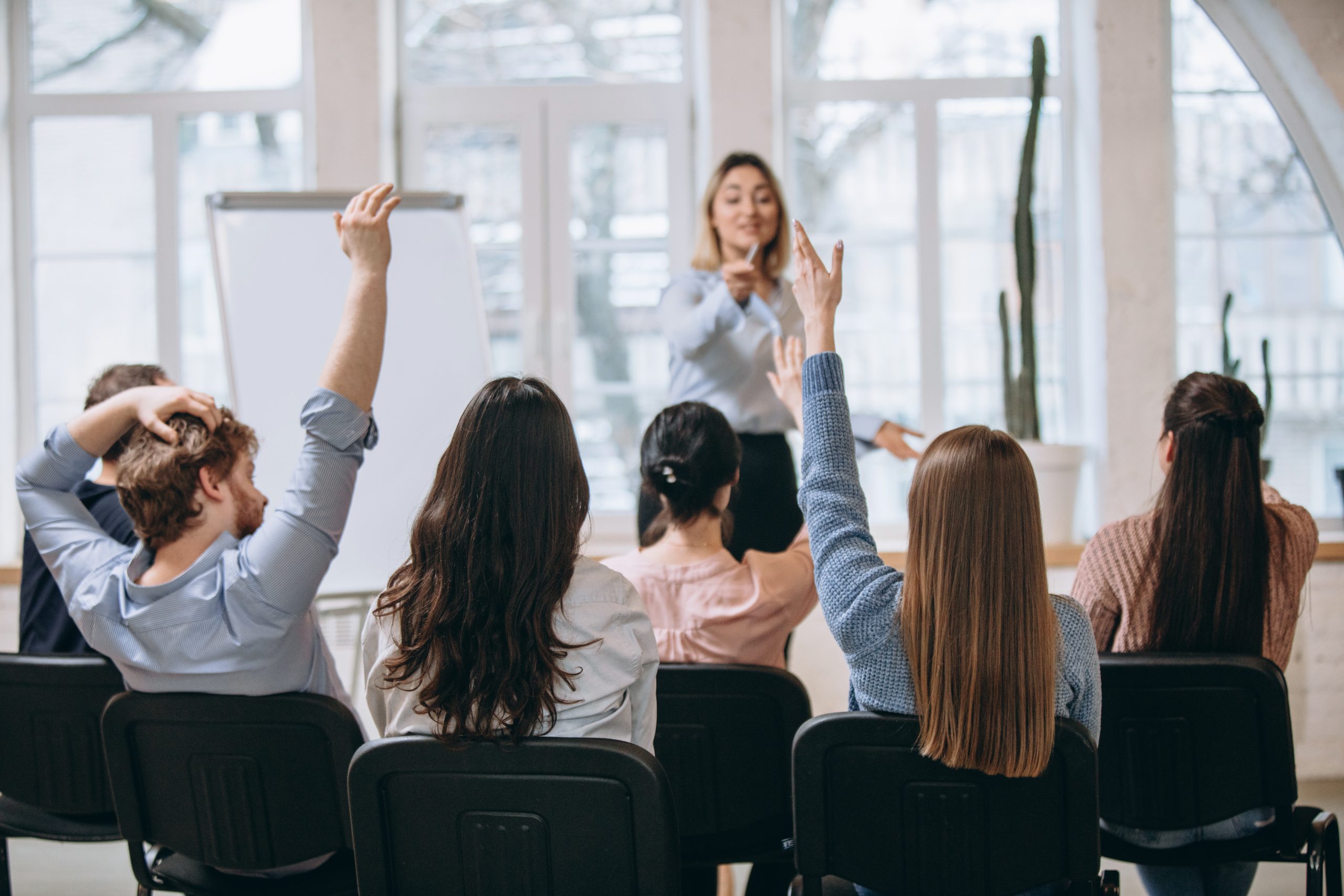 female speaker giving presentation hall university workshop audience conference hall scaled